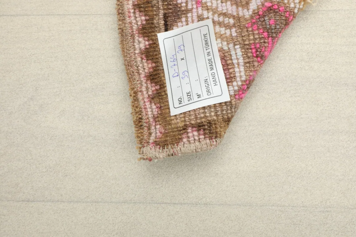 Underside of the rug showing the cotton foundation and a product label