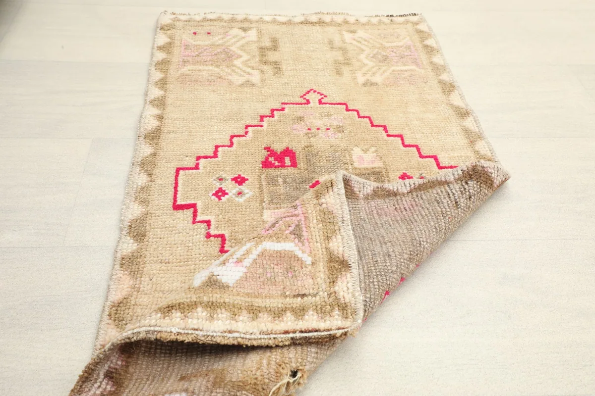 Partial fold of the rug revealing the backside and construction