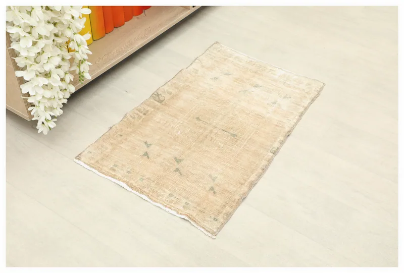 Top view of the 1'7" x 2'7" beige vintage Anatolian rug with subtle geometric motifs.