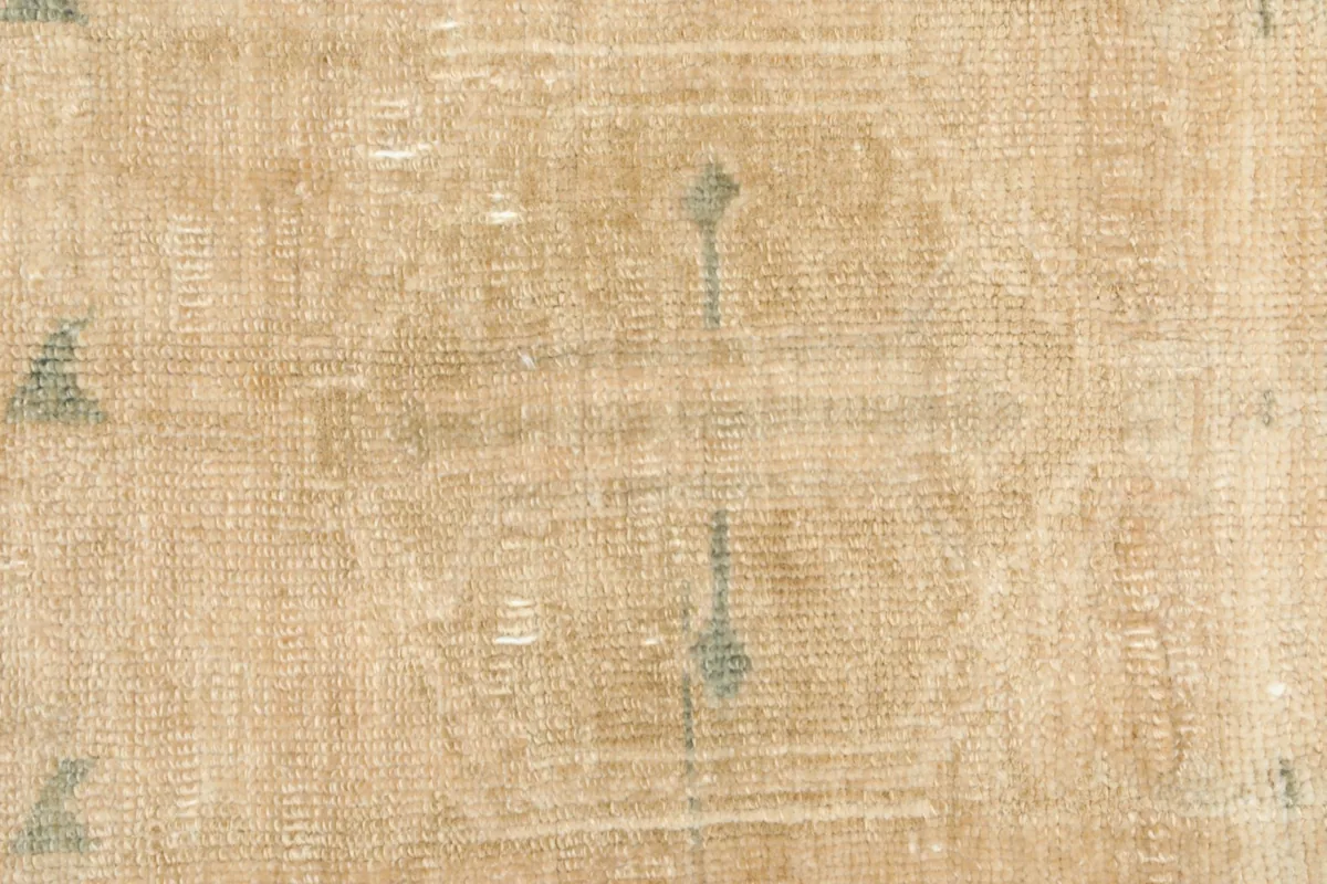 Detailed view of the rug's texture and subtle color shifts from its vintage character.