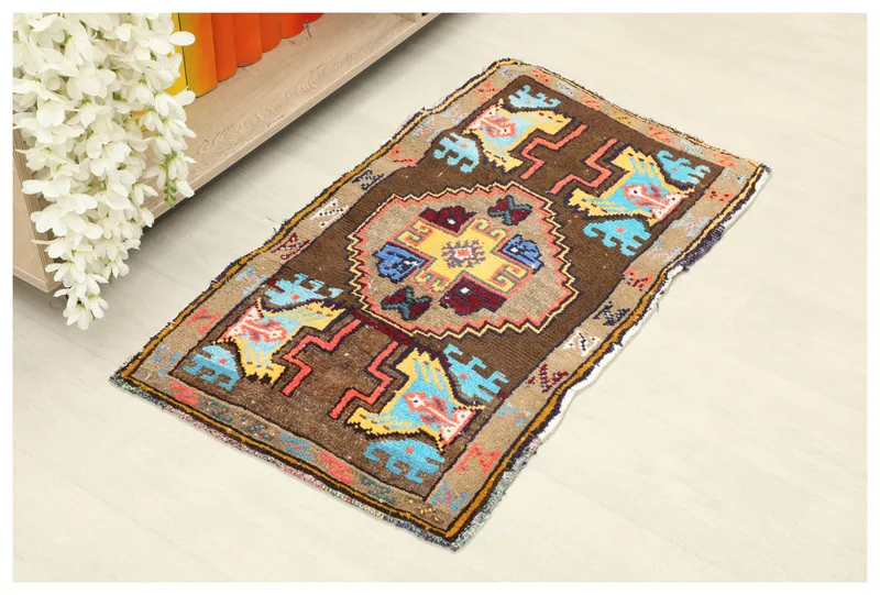 Full top view of the vintage brown tribal medallion rug on a white background