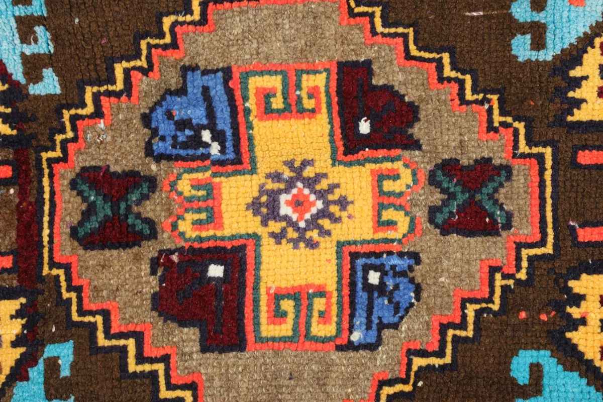 Detailed view of the intricate knotting and color variations within the rug's central design