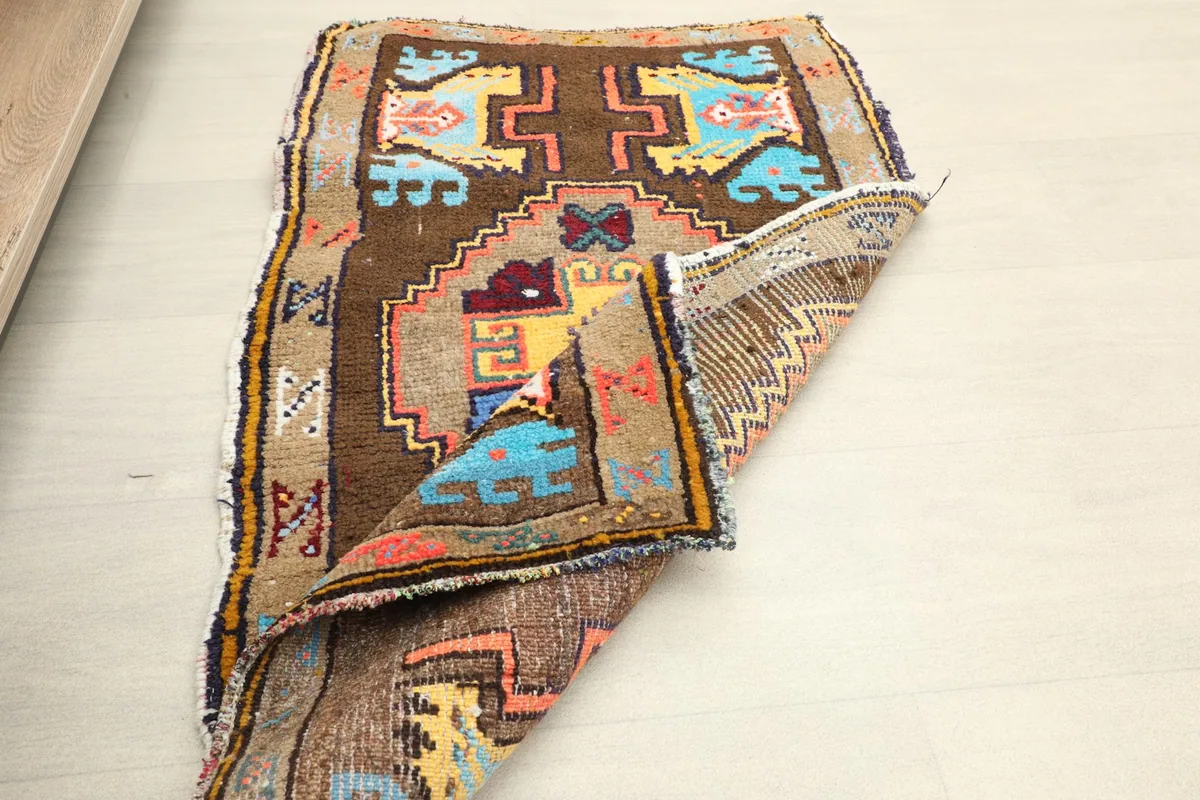 Reverse side of the hand-knotted rug, revealing the cotton foundation and knot structure