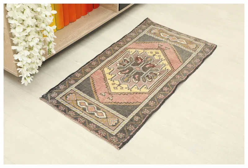 Full overhead view of the 1'9" x 3'5" vintage Anatolian rug on a white background.