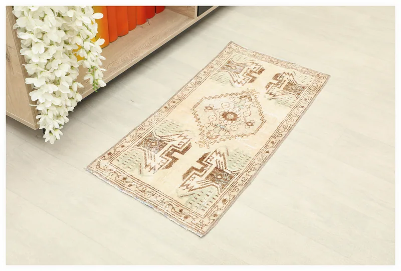 Full top view of the 1'5" x 2'11" beige Anatolian vintage doormat on a white background.