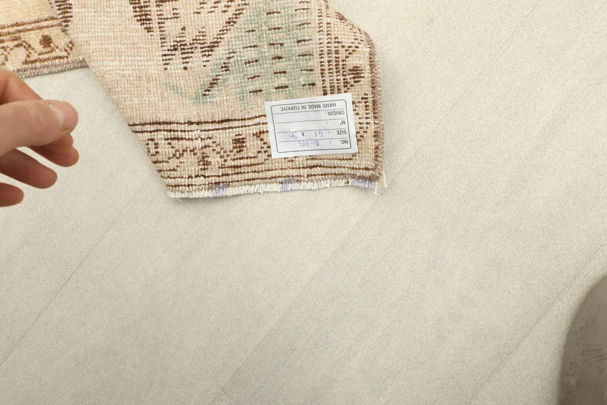 Close-up of the rug's label on the back, confirming its origin and material composition.