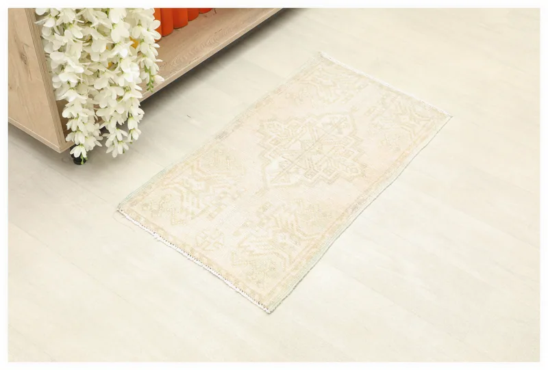 Full top view of the ivory and beige vintage Anatolian doormat on a white background.