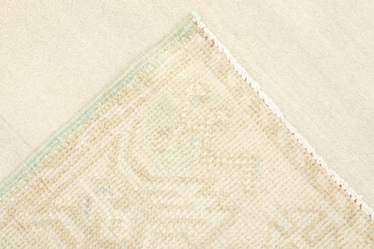 Close-up of a corner, showing the subtle border design and slight color variation.