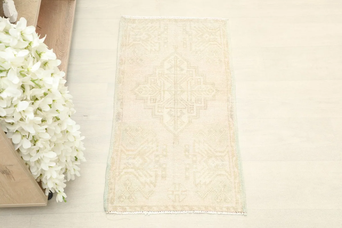 Overhead view of the small hand-knotted Anatolian rug, showcasing its subtle geometric pattern.