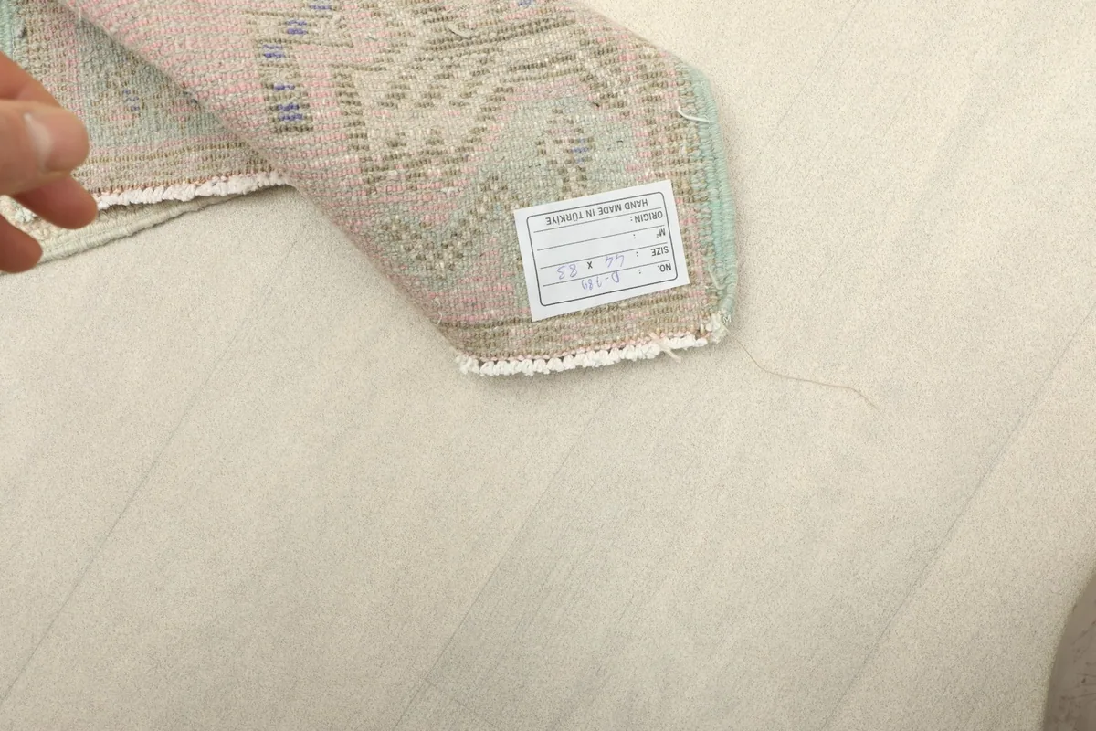 Close-up of the rug's label on the back, confirming its origin and material.