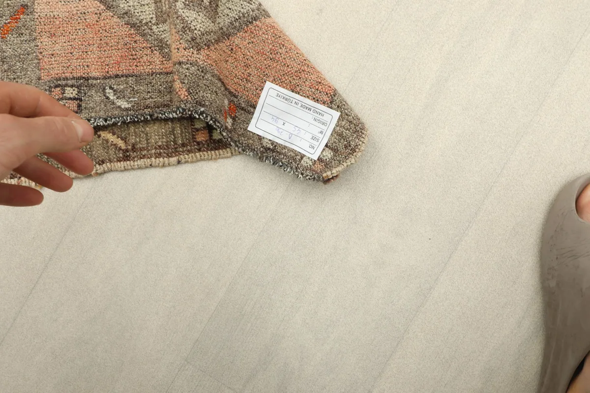 Underside of the rug revealing the cotton foundation and the product label with sizing.