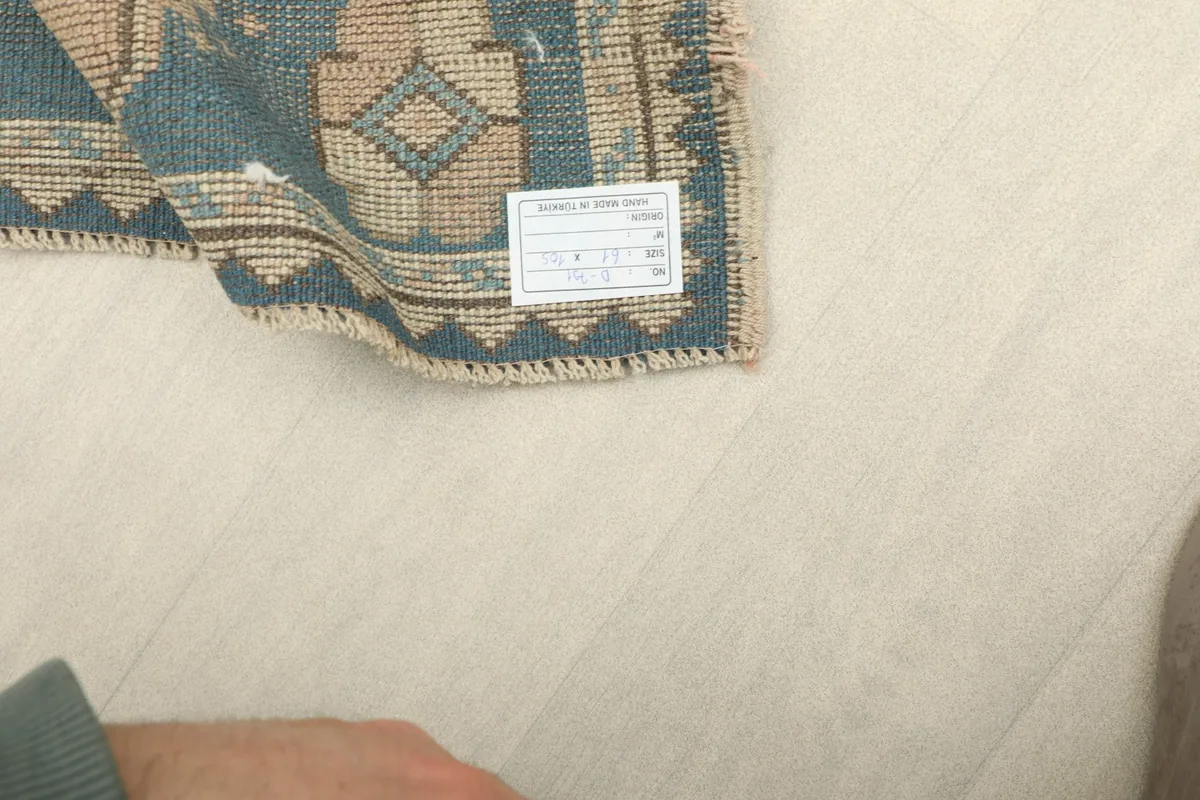 Back of the rug showing the cotton foundation and a product label