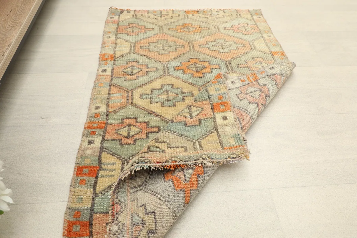 Another view of the rug partially folded, illustrating its flexibility and construction.