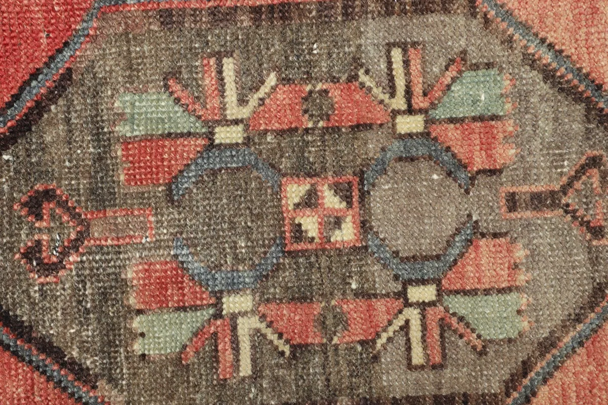 Tight detail of the intricate geometric patterns within the gray central medallion.
