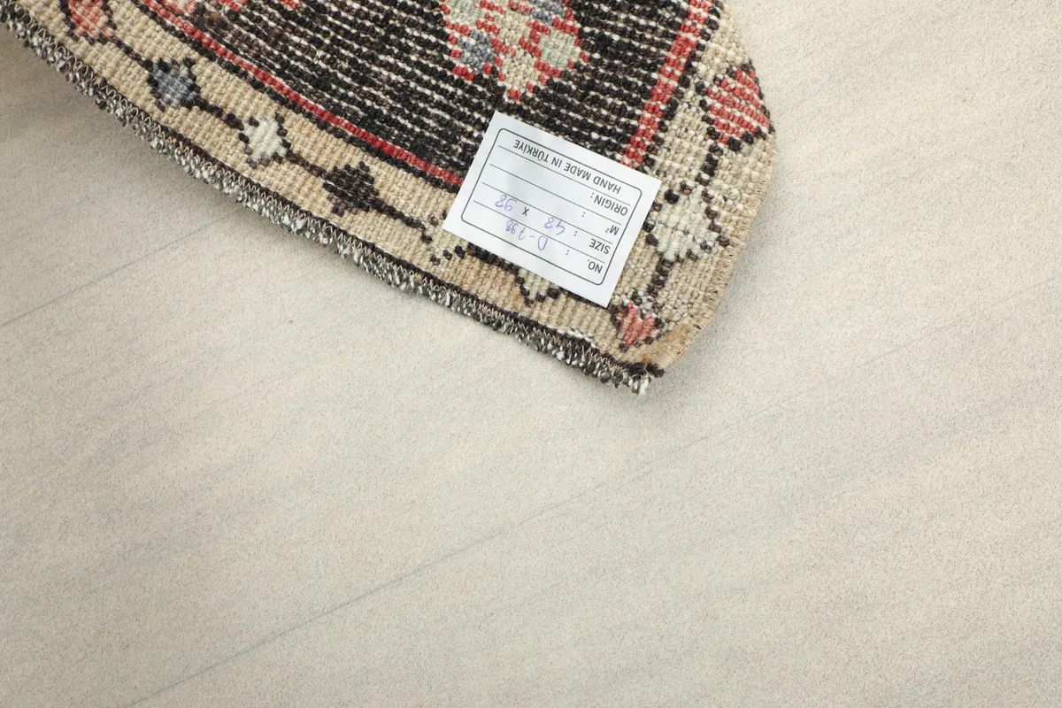 Close-up of the rug's back, displaying the hand-knotted cotton foundation and product label.