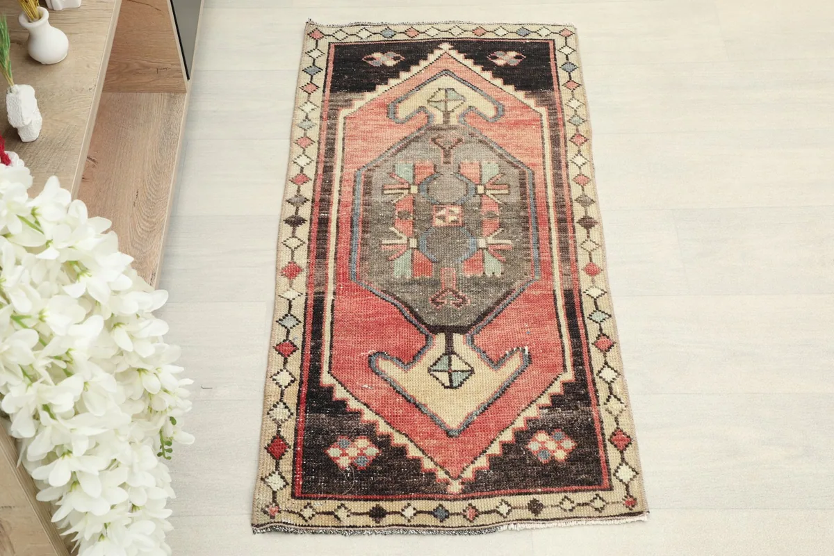 Overhead view of the vintage Anatolian rug, highlighting its central medallion and geometric border.