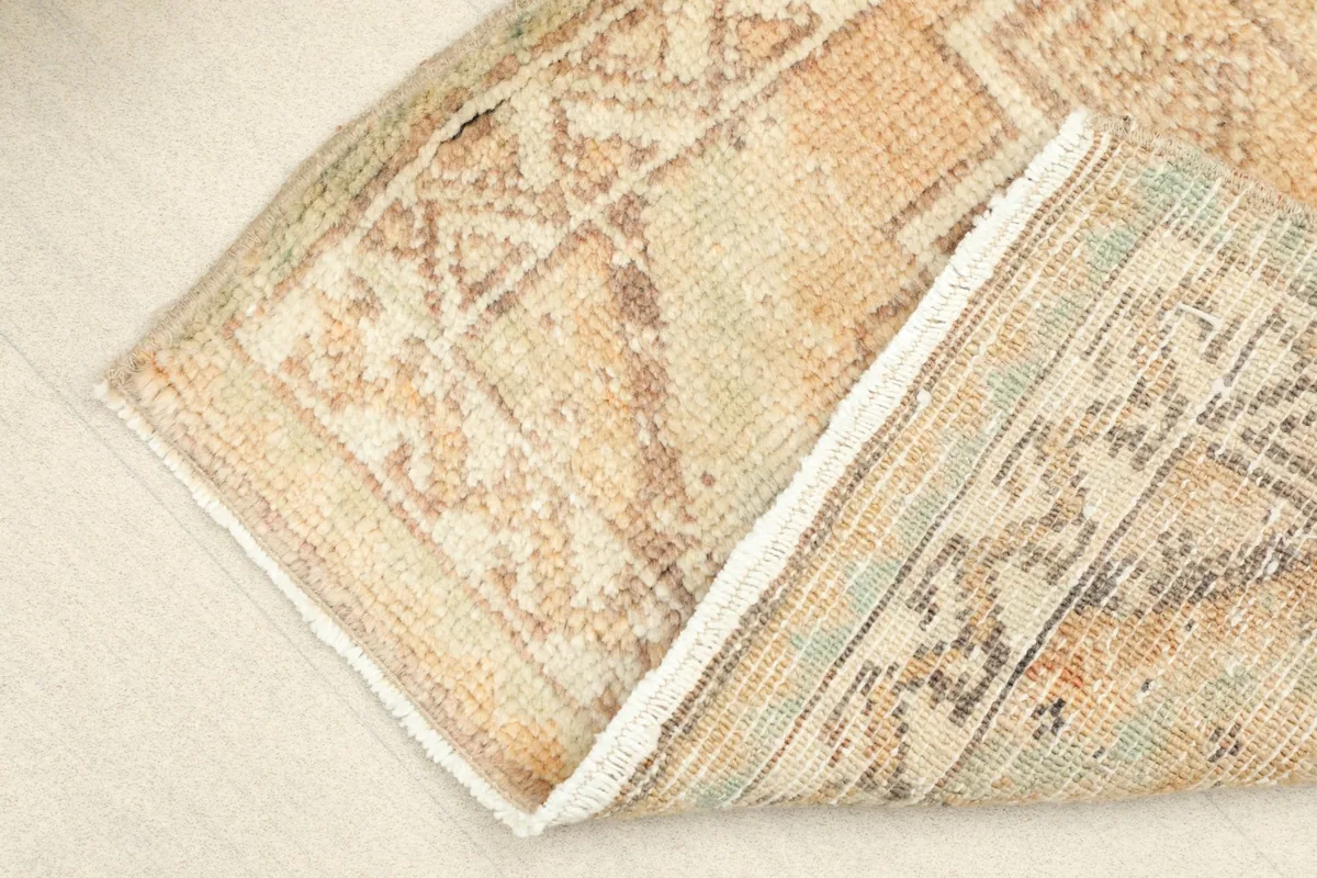 View of the rug's back, showing the cotton foundation and fine hand-knotting