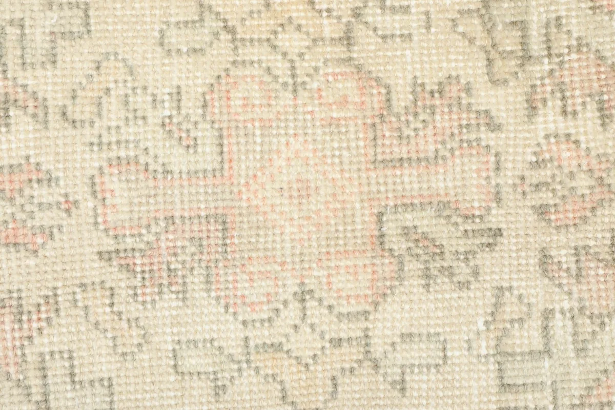 Close-up detail of the central motif and the subtle color variations in the wool pile.