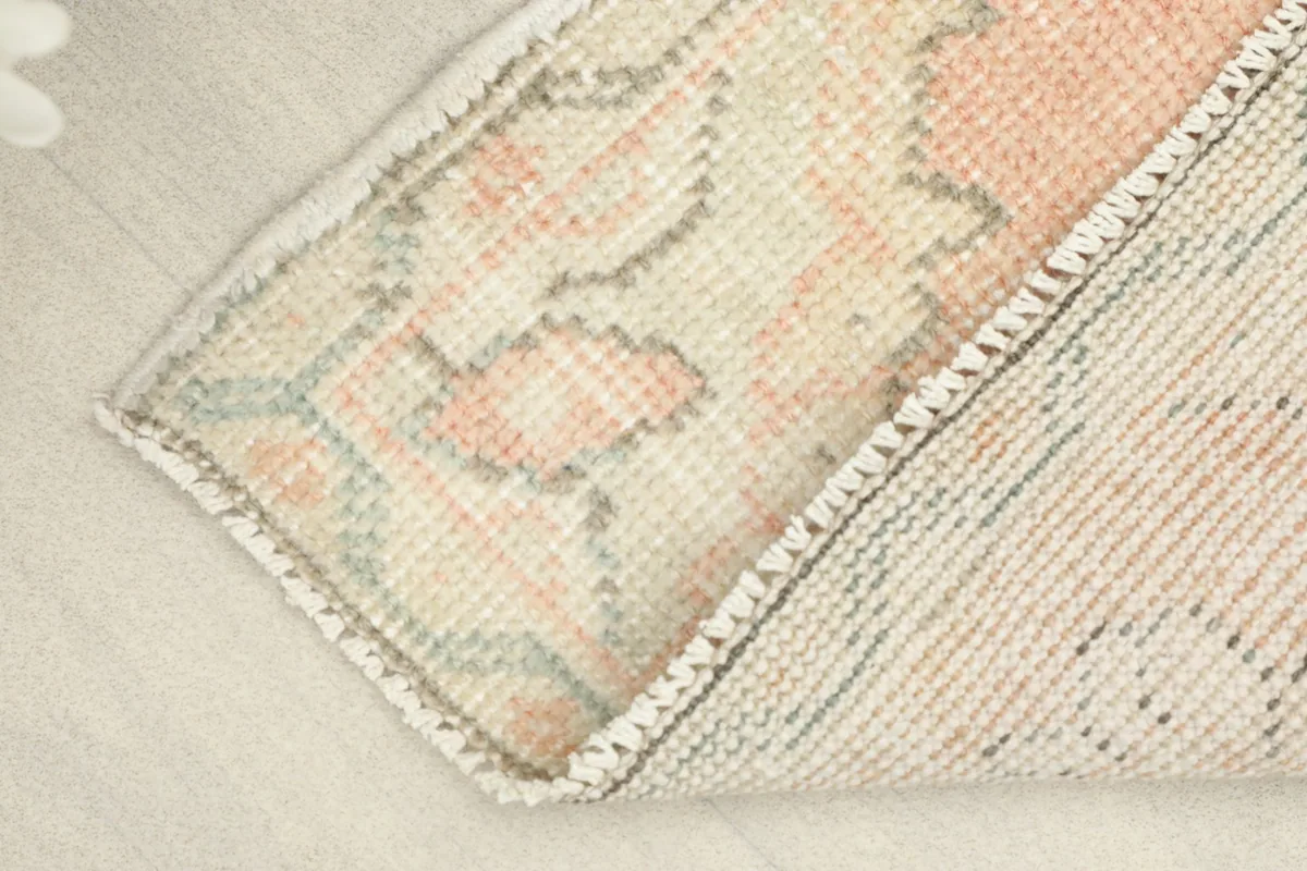 View of the back of the rug, revealing the cotton foundation and the hand-knotted structure.