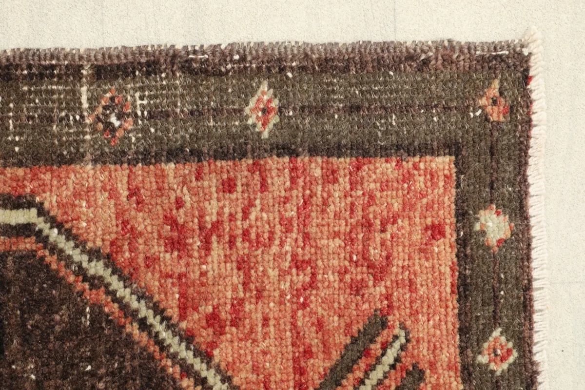Another corner view of the doormat, focusing on the border design and the texture of the low pile.