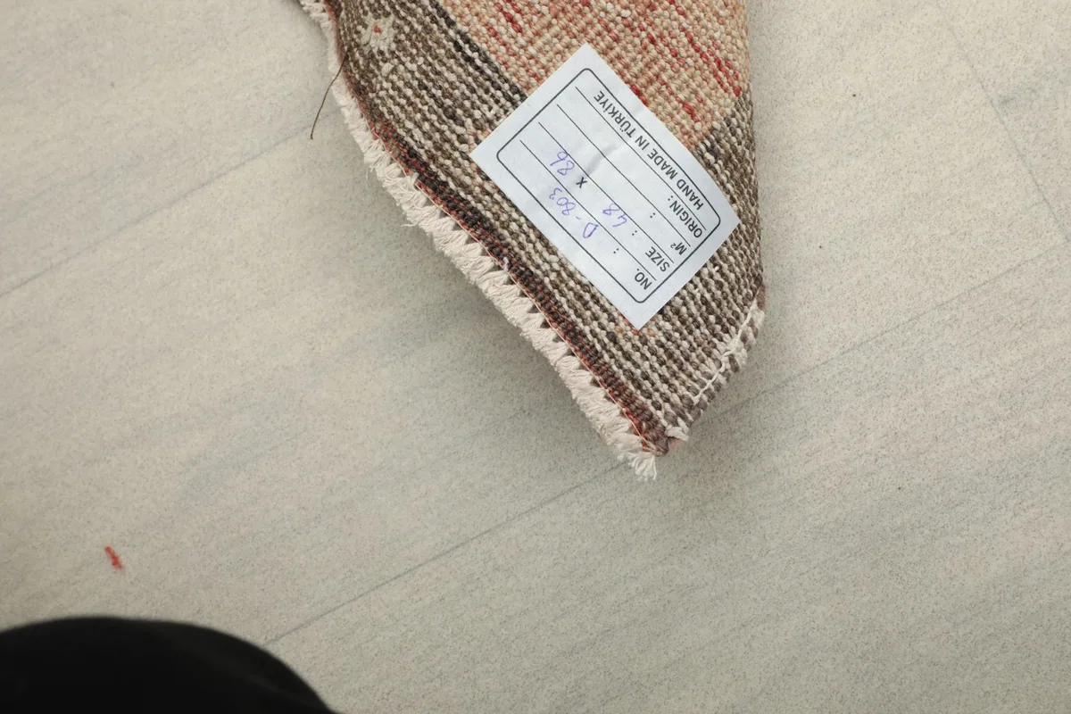 Close-up of the product label attached to the back of the rug, indicating its origin and materials.