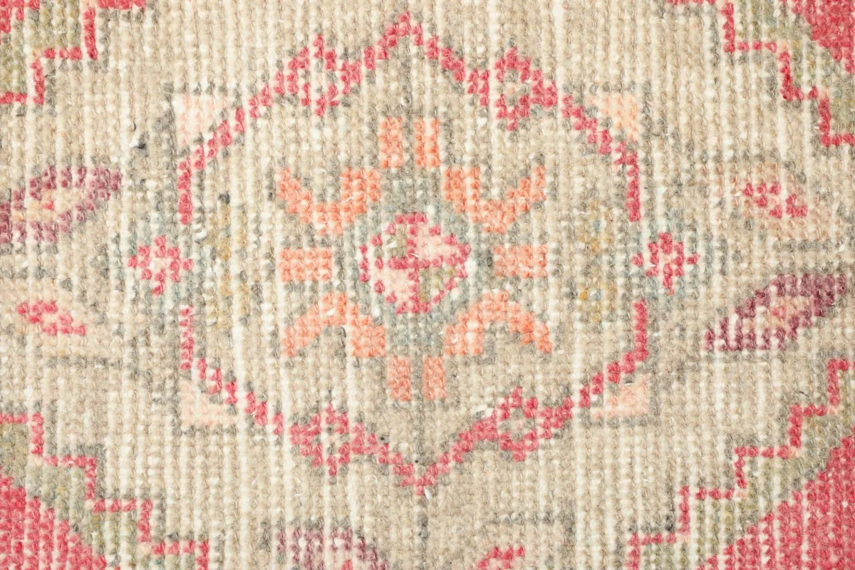 Close-up detail of the central medallion with orange and rose tones
