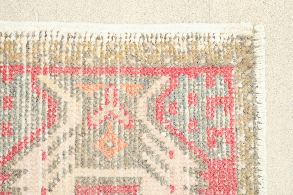 Close-up of the geometric patterns and colors in the rug's field