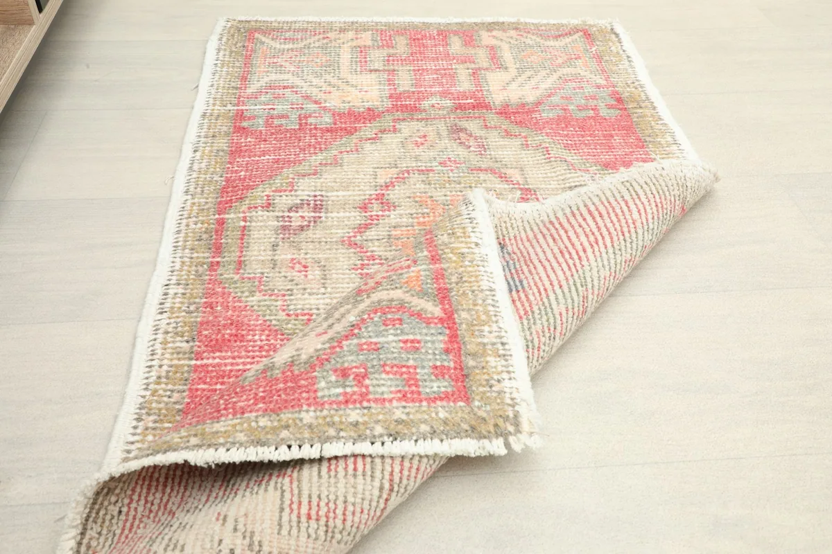 Rug partially folded, displaying the wool pile and cotton foundation