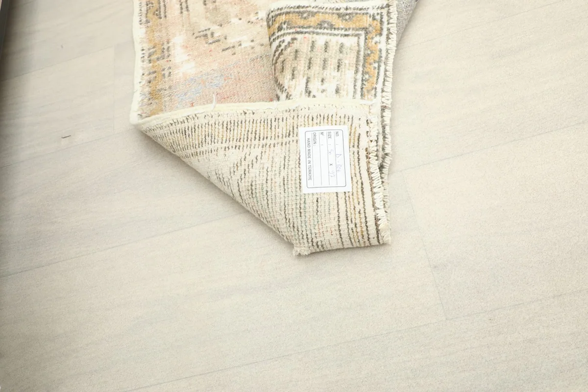 Close-up of the back of the rug, showing the tightly woven cotton foundation and hand-knotted knots.