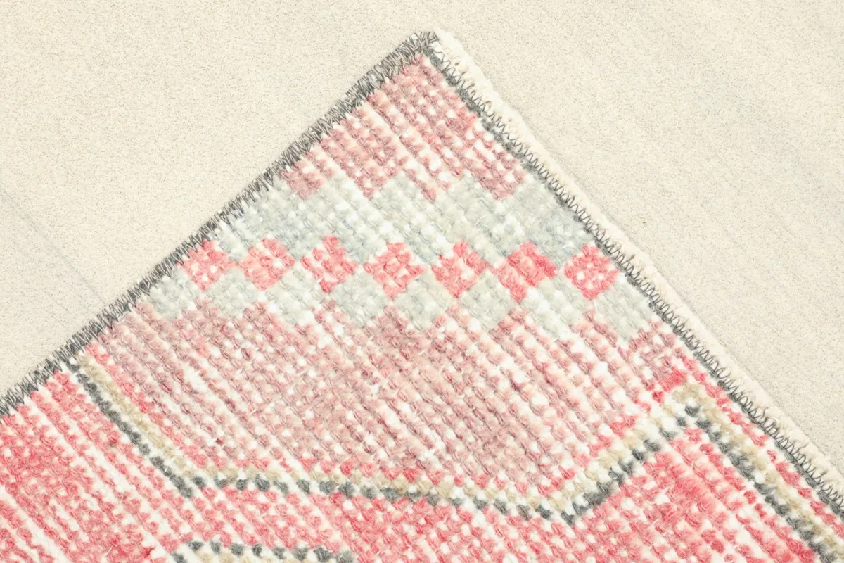 Close-up of a corner, showing the distinct pattern of the rose border and the tightly woven edge.