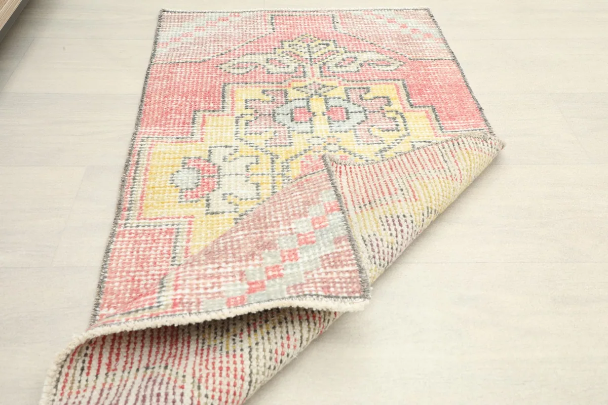 The rug folded to show its flexibility and the reverse side with its characteristic weave.