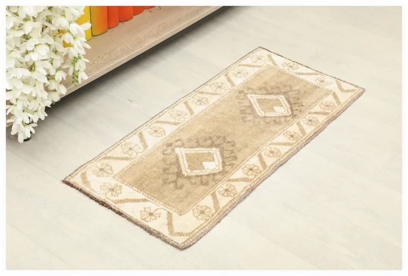 Full top view of the tan and ivory geometric vintage Anatolian doormat