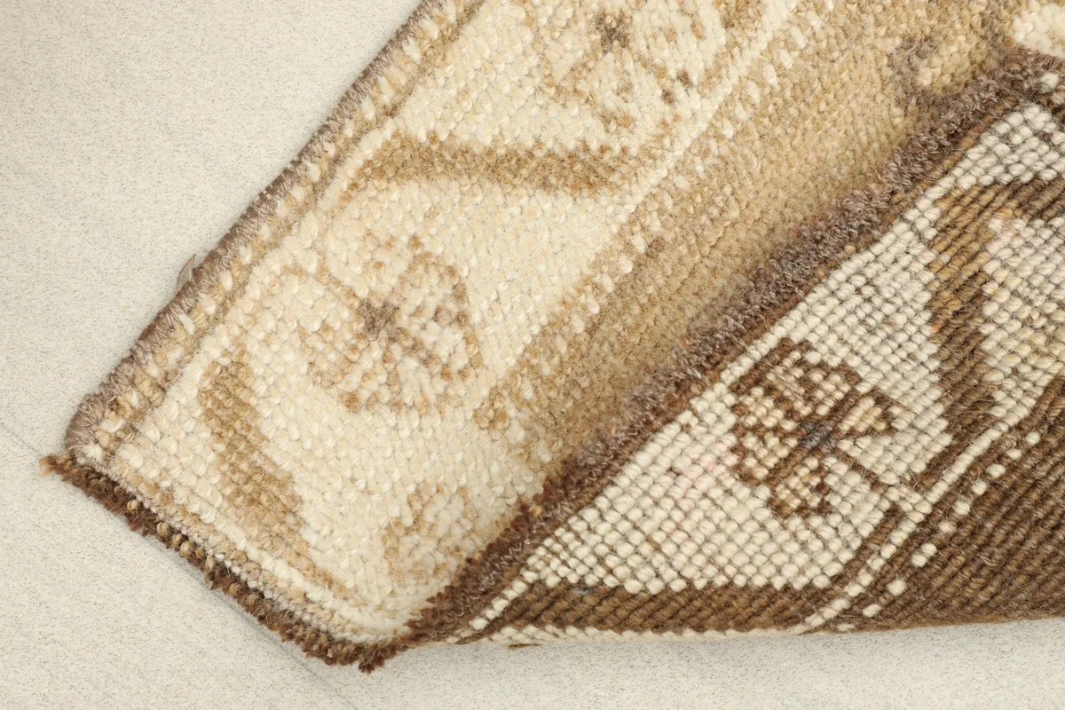 View of the back of the rug, showing the dense hand-knotted wool on cotton foundation