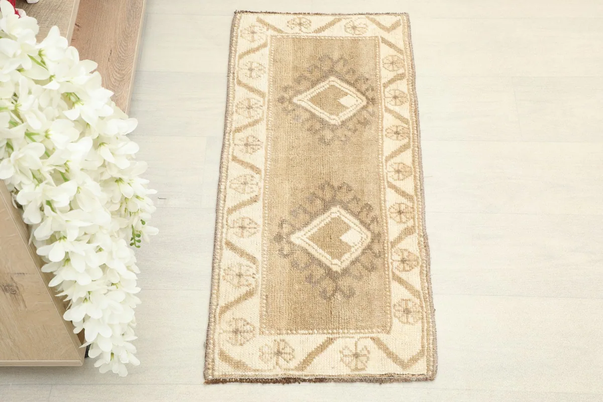 Overhead shot showing the full design of the tan geometric mini rug