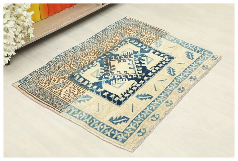 Full top view of the 1'3" x 3'4" ivory and blue vintage Anatolian runner rug