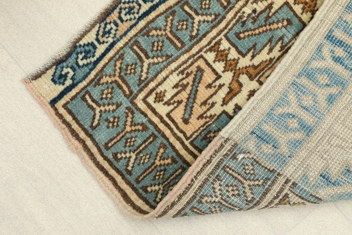 View of the back of the hand-knotted wool pile on cotton foundation, showing construction
