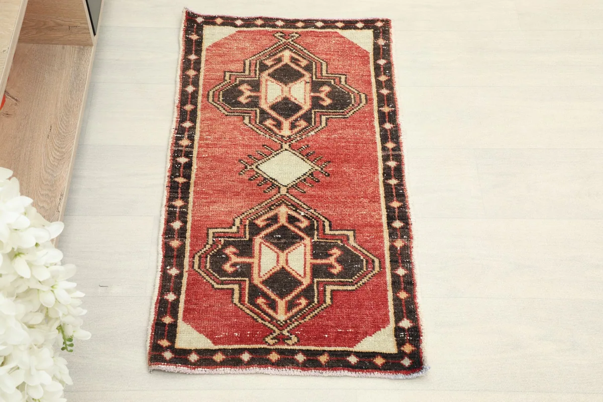 Overhead view of the hand-knotted red and black geometric Anatolian rug.