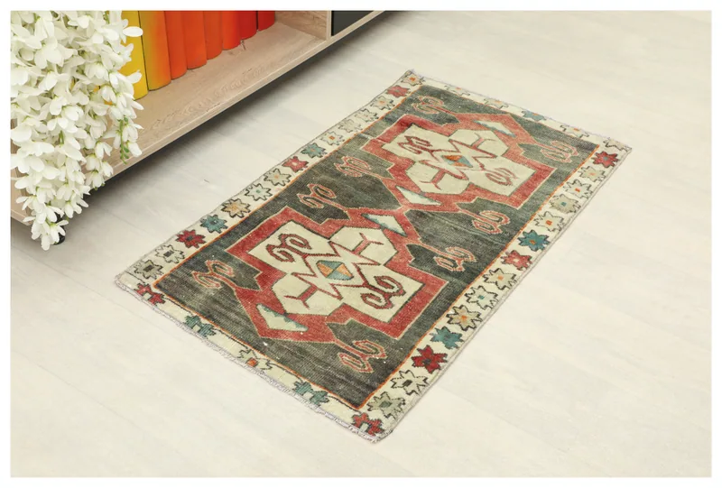 Full top view of the 1'10" x 3'2" charcoal and red geometric vintage Anatolian rug on a white background.