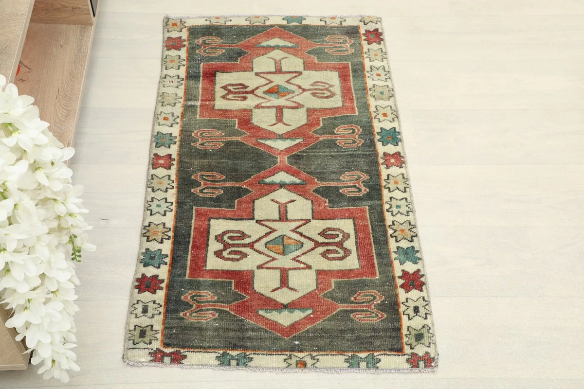 Overhead view showcasing the full length of the charcoal and red geometric wool rug.