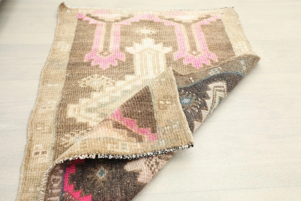 The rug partially folded, displaying both the top pattern and the reverse side.