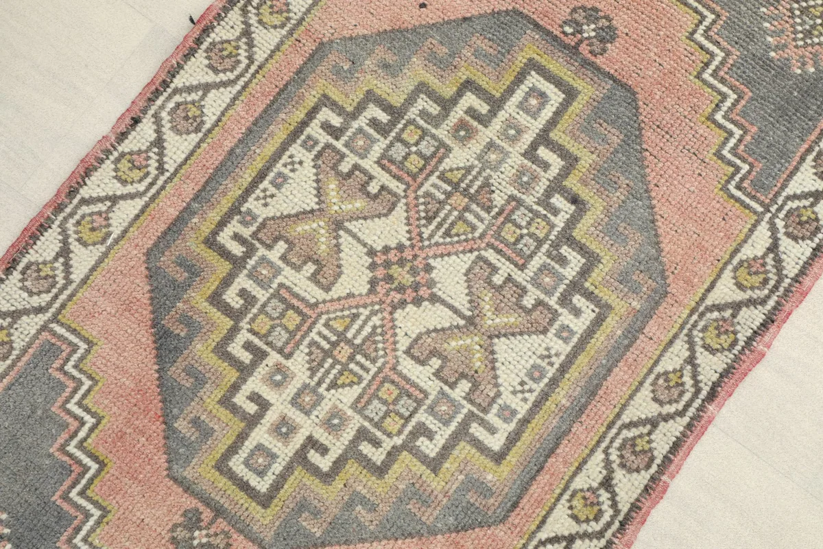 Angled view highlighting the central geometric medallion and surrounding patterns of the rug.