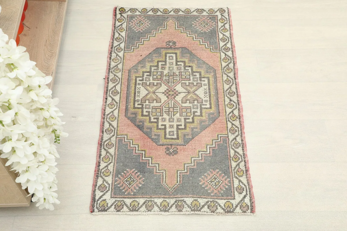 Overhead view showcasing the full rose and gray geometric design of the vintage Anatolian rug.