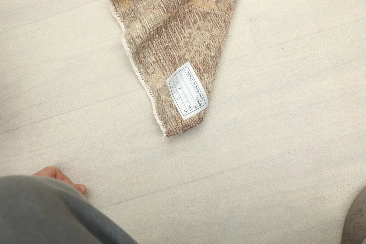 Partial view of the rug with its label visible, indicating its origin and material.