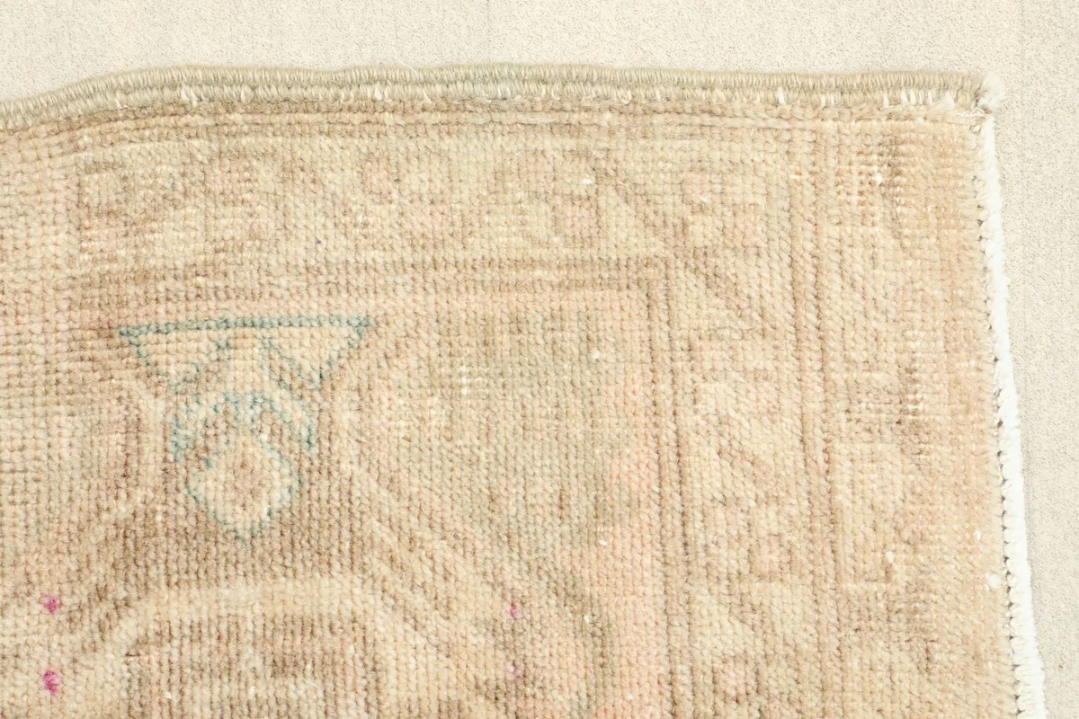 Close-up of the low wool pile, revealing the texture and slight wear from its vintage nature.