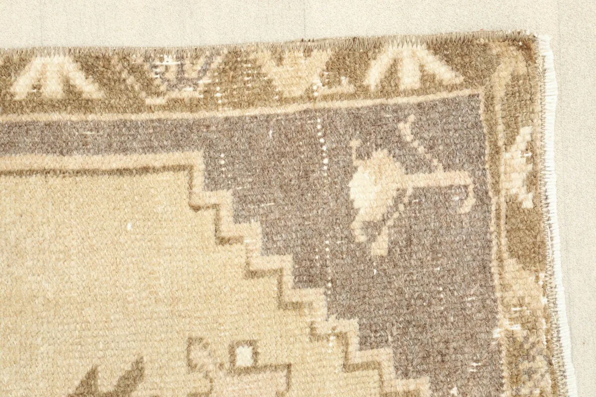 Detail of the border and field, showing the intricate step-like patterns and color variations.
