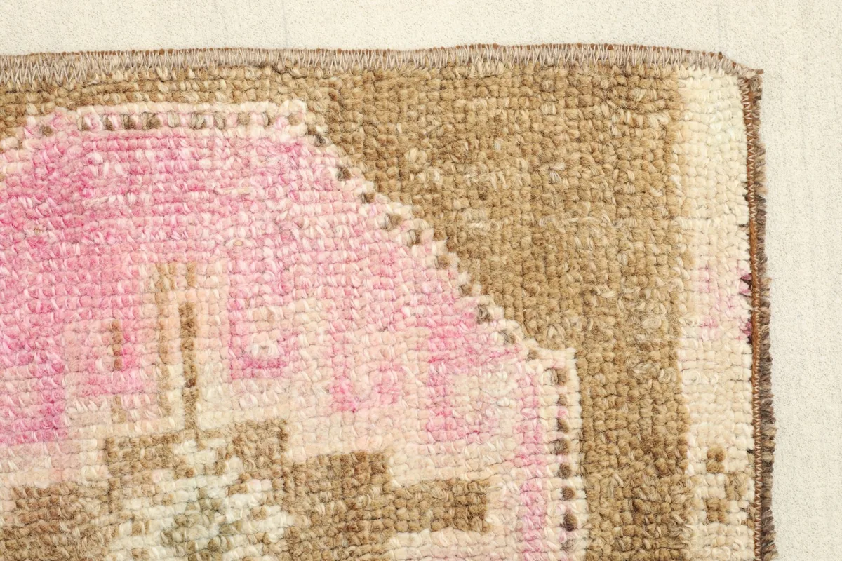 Detail of the rug's edge, highlighting the hand-knotted construction and color variations