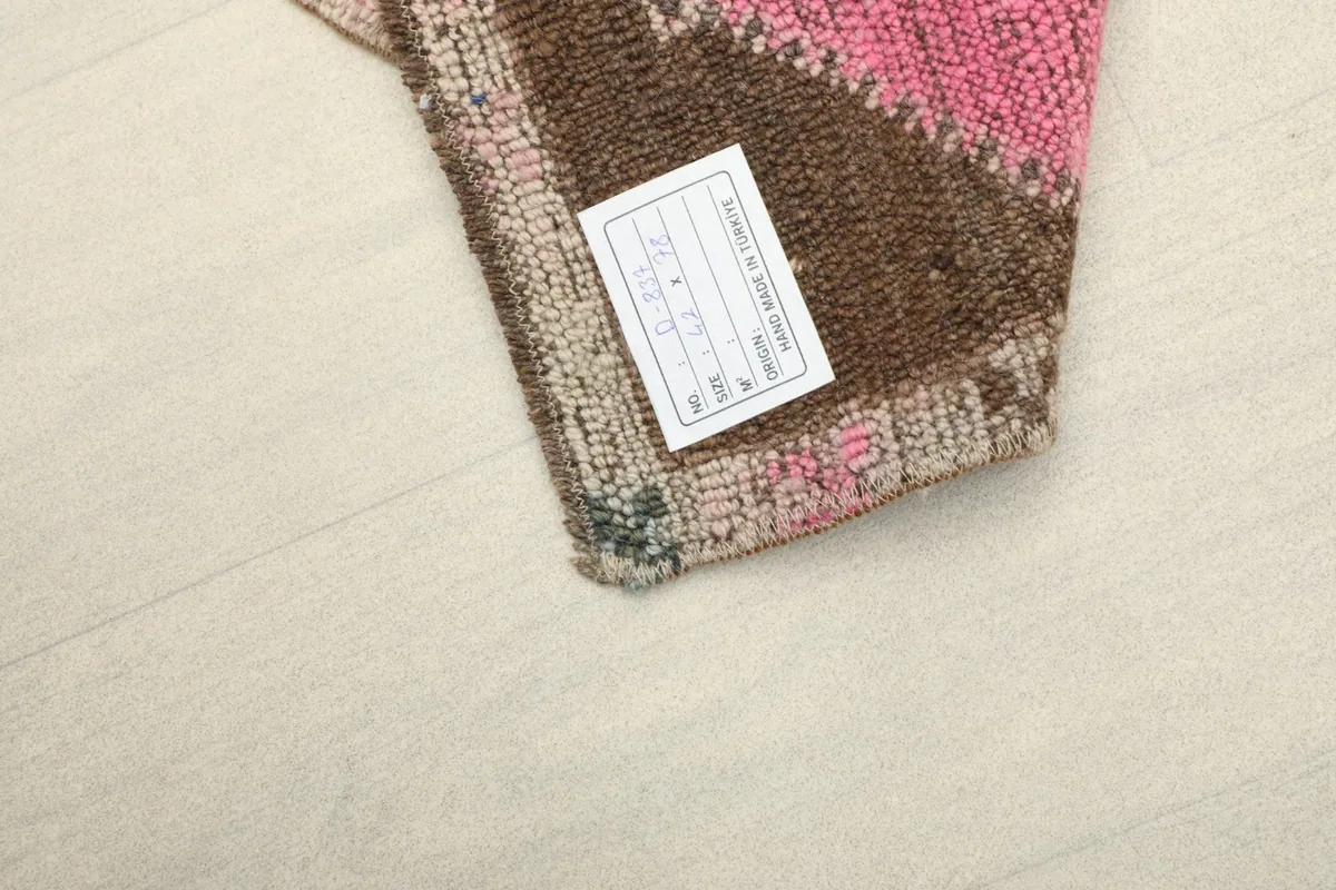 Close-up of the rug's back, showing the knotting and the product tag