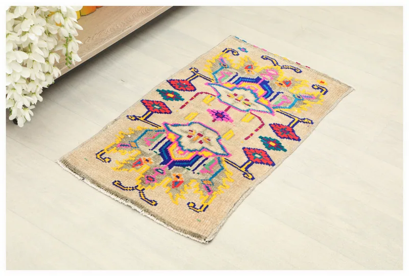 Full top view of the beige tribal geometric vintage rug on a white background.