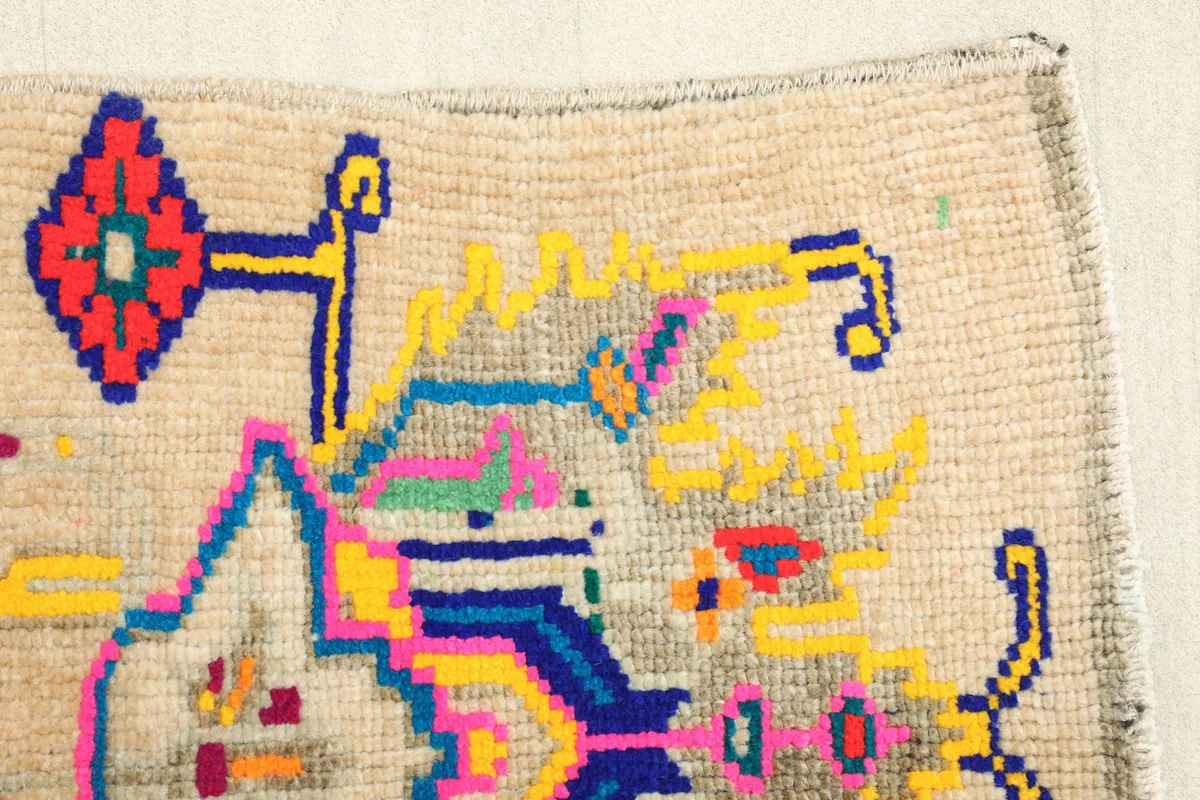 Detail of the top-right corner of the rug, illustrating the edge finishing and a section of the pattern.
