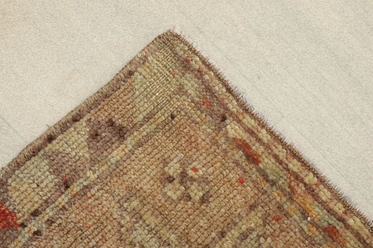 Angled view of a corner of the rug, highlighting the texture and color variations.